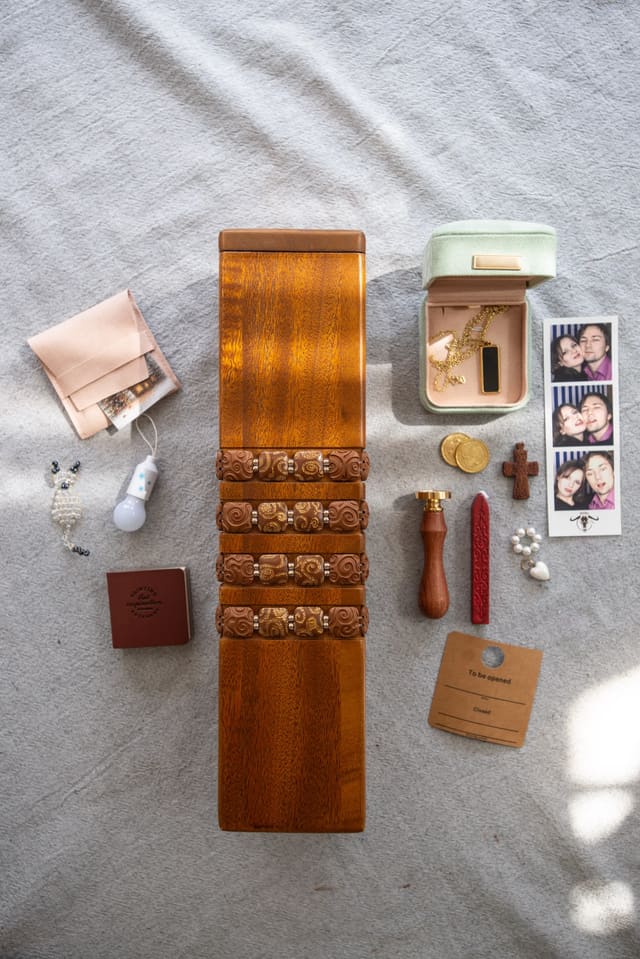 Family photographs laid out around an open handcrafted Memora time capsule